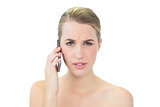 Frowning attractive blonde on the phone