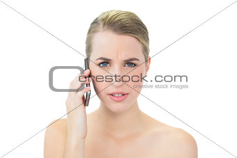 Frowning attractive blonde on the phone
