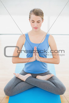 Peaceful attractive blonde relaxing in lotus position