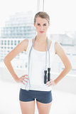 Motivated sporty woman holding skipping rope