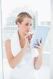 Focused sporty woman using tablet pc