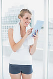 Happy sporty woman using tablet pc