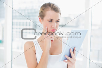 Focused sporty woman using tablet computer