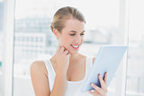 Smiling sporty woman using tablet computer