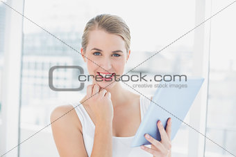Cheerful sporty woman using tablet computer