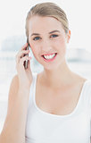 Close up on cheerful sporty woman having a phone call