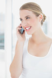 Close up on smiling sporty woman having a phone call