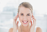 Close up on smiling sporty woman listening to music