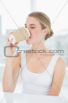 Cute blond woman drinking coffee