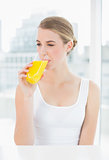 Cute blond woman drinking orange juice