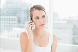 Thoughtful blond woman on the phone