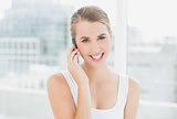 Smiling blond woman on the phone