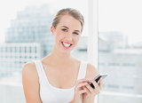 Happy blond woman text messaging