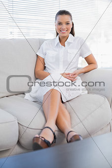 Attractive brunette sitting on cosy couch