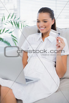 Happy pretty woman buying online using laptop