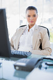 Serious businesswoman sitting on swivel chair