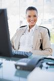 Smiling businesswoman sitting on swivel chair