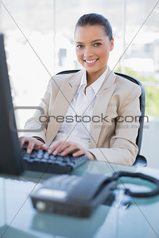 Cheerful gorgeous businesswoman working on computer