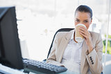 Peaceful sophisticated businesswoman drinking coffee