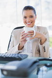 Cheerful sophisticated businesswoman holding coffee
