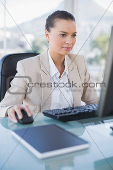 Concentrated businesswoman working on computer