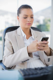 Peaceful sophisticated businesswoman texting