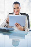 Cheerful sophisticated businesswoman holding tablet computer