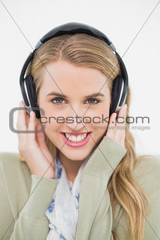 Smiling cute blonde listening to music