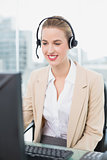 Happy pretty agent wearing headset dealing with customer
