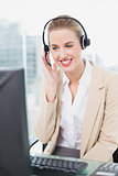 Smiling pretty agent wearing headset dealing with customer