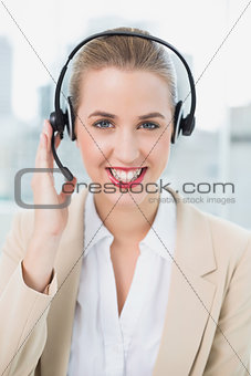 Smiling pretty call centre agent wearing headset