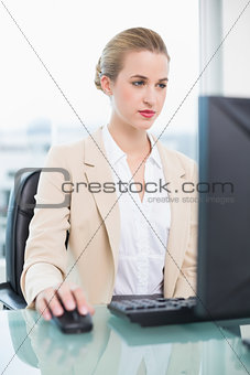 Focused attractive businesswoman working on her computer