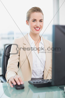 Smiling attractive businesswoman working on her computer