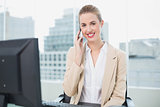 Cheerful attractive businesswoman on the phone