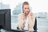 Worried attractive businesswoman on the phone