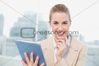 Happy attractive businesswoman using her tablet