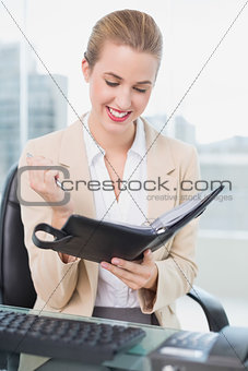 Smiling attractive businesswoman holding her agenda