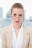 Serious businesswoman with glasses posing