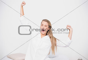 Yawning cute model stretching in cosy bed