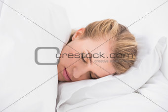 Pretty model sleeping in cosy bed