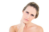 Upset woman looking at camera with a sore neck