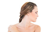 Woman looking aside with one hand on shoulder eyes closed