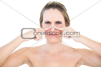 Pretty woman pressing blackhead on her nose