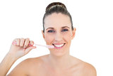 Smiling pretty woman brushing her teeth