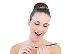 Cheerful natural young woman using nail file