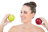 Happy woman holding red and green apple