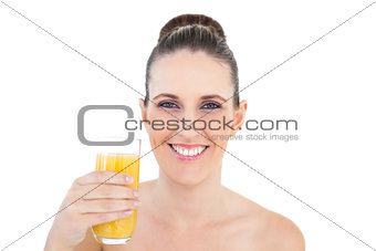 Woman holding glass of orange juice