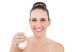 Smiling woman holding glass of milk