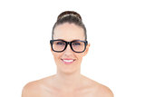 Smiling woman wearing large glasses looking at camera