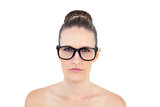 Serious woman wearing glasses looking at camera